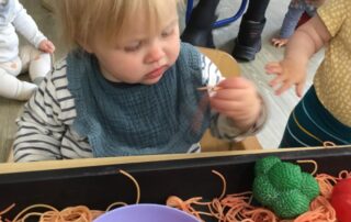 Nursery child engaging in a textures based activity